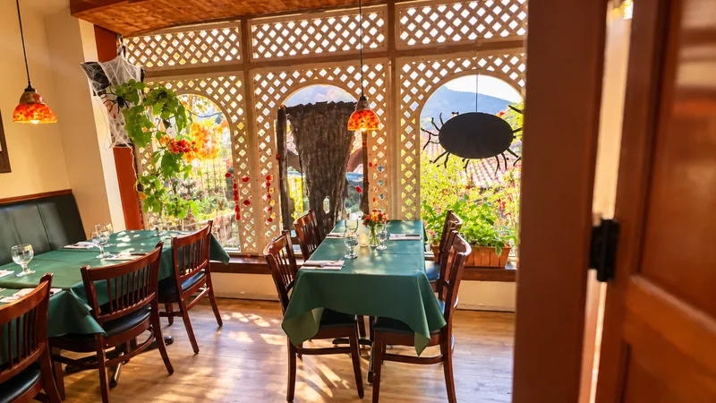 Window tables behind white lattice screens with hanging red lamps